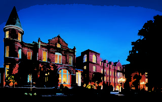 A painting of a building at night with lights.